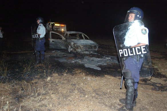 One of the 2 cars torched and destroyed during a melee between a group of youths and police in Dubbo, Sunday, January 1, 2006.