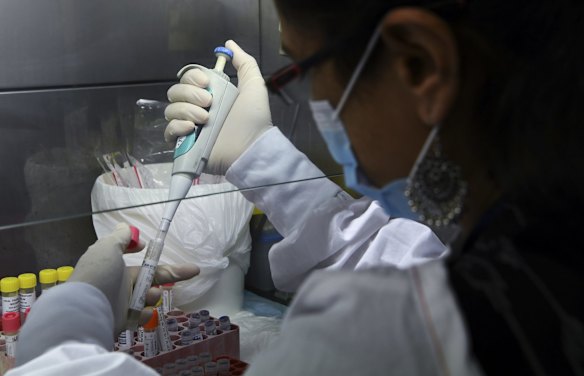 Senior Hospital Scientist Vidiya Ramachandran carries out sample aliquoting of a coronavirus sample.