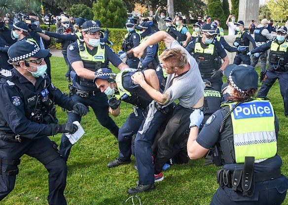 A police officer and protester in a scuffle.