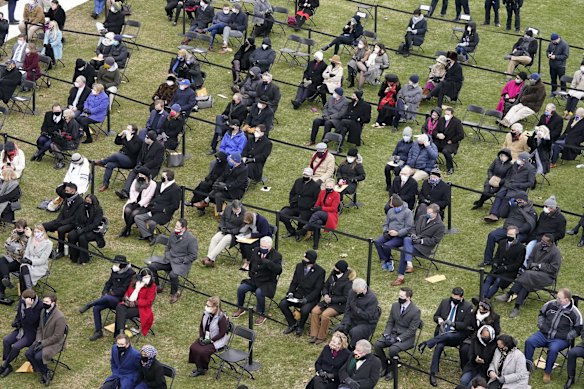 A social distanced crowd, looks on for the 59th Presidential Inauguration at the U.S. Capitol in Washington, Wednesday, Jan. 20, 2021. 