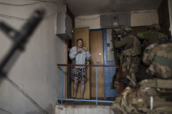 Security Service of Ukraine troops storm a building during an operation to arrest suspected Russian collaborators in Kharkiv.