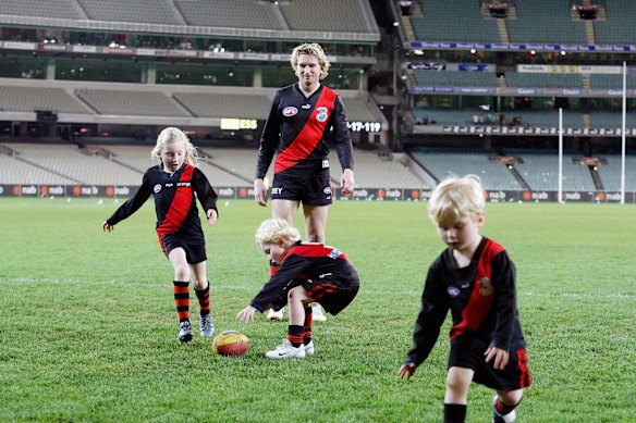 AFL Football Round 21 Essendon v Richmond at the MCG. 
James Hird has a kick on the MCG with his children Tom, Stephanie, Alexander after the game, August 26, 2007. 
