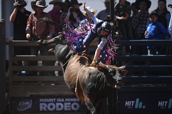 16 year-old Sharlette Johnson, the only female to compete in the Junior Bull Ride event, in action at the Mount Isa Mines Rodeo.