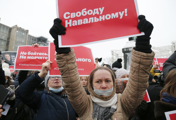 Women hold placards that read: “Freedom for Navalny!“.