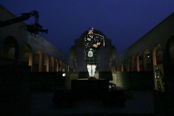 The bagpiper during the Anzac Day commemorative service at the Australian War Memorial in Canberra.