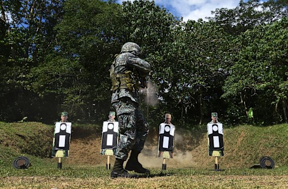 A Philippine marine fires at a target during training with the Australian Army Land Mobile Training Team at the firing range.