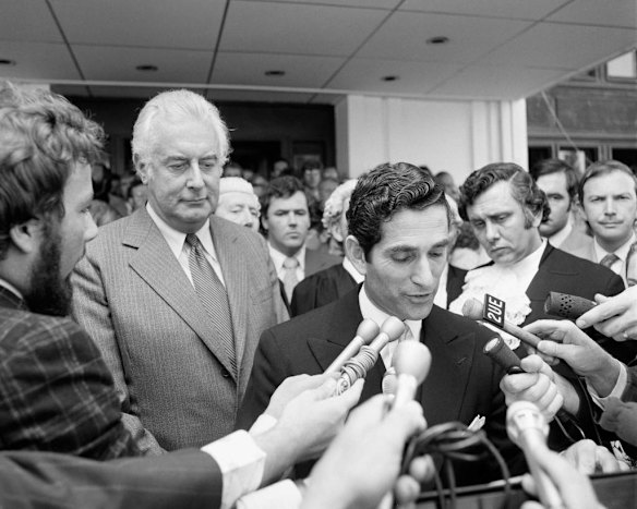 Gough Whitlam looks on quizzically as the Governor-General s Official Secretary, David Smith, announces that Sir John Kerr has dismissed the Whitlam government and installed Malcolm Fraser as caretaker Prime Minister.