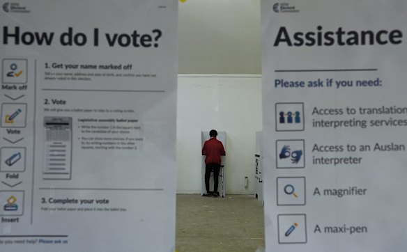 A woman votes in the Upper Hunter by-election at the pre-poll booth in Muswellbrook.
