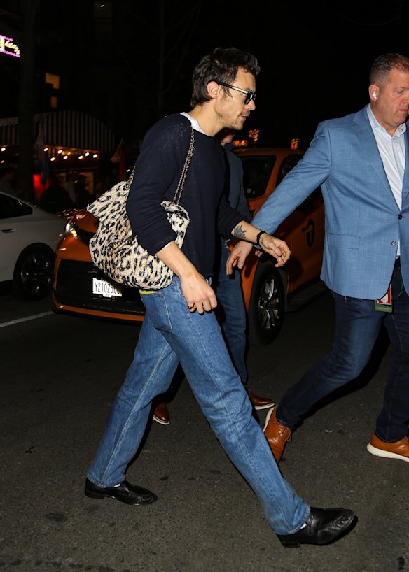 Harry Styles in New York last month, carrying an animal print Chanel bag.
