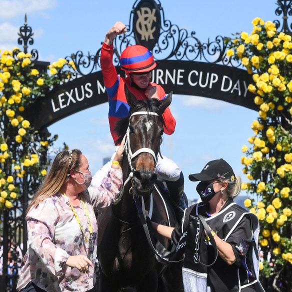 James McDonald raises his hand in triumph on return to the mounting yard at Flemington.