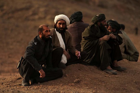 Uruzgan Police Chief, Matiullah Khan, left, talks with local men in Sagi area, Tarin Kowt district, Uruzgan, Afghanistan.