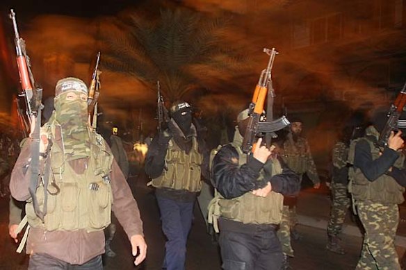 Members of the Ezzedine Al-Qassam Brigade, the armed wing of the Palestinian movement Hamas, celebrate in Gaza City after Egyptian President Hosni Mubarak resigns.