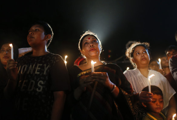 Bangladeshis light candles and sing songs as they pay tribute to those killed in the attack at a cafe in Bangladesh blamed on  Jama’atul Mujahideen Bangladesh in 2016.