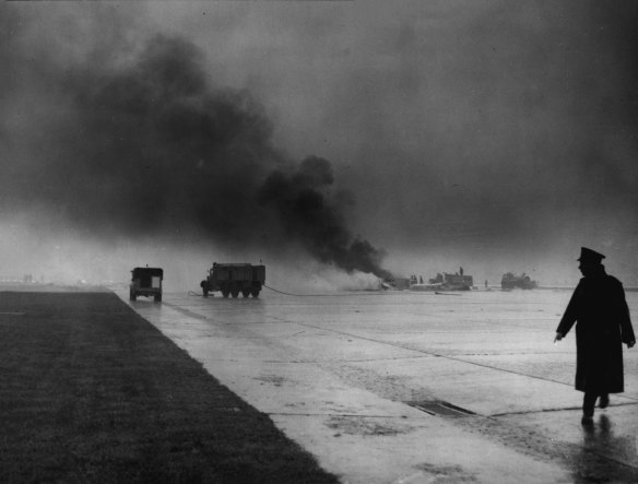 Smoke rises from the crash site of the Vulcan bomber at London Airport.