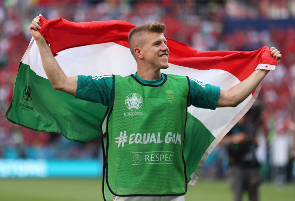 David Siger of Hungary celebrates with a flag following the draw with France.