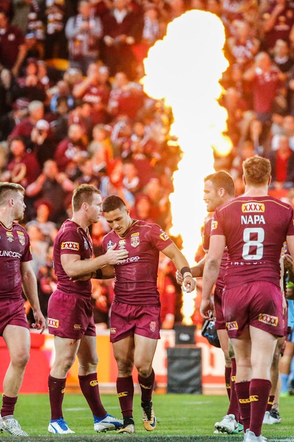 Valentine Holmes of the Maroons celebrates a try with team mates during the State of Origin series decider. 