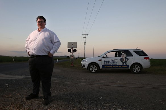 Mr Christensen with his car, a Ford SUV with decals of his name, a jolly cartoon of him and his slogan "Standing up for the North".