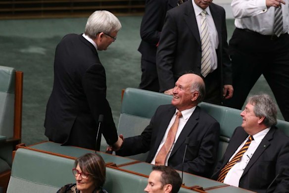 Kevin Rudd shakes hands with outgoing Independent MP Tony Windsor during a divison on Government changes to immigration visa subclass 457 at Parliament House.
