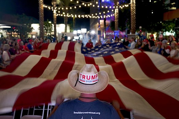 President Donald Trump supporters wave a flag during an election watch party in Chandler, Arizona. 