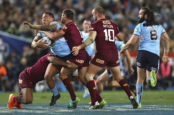 Tyson Frizell of the Blues is tackled.