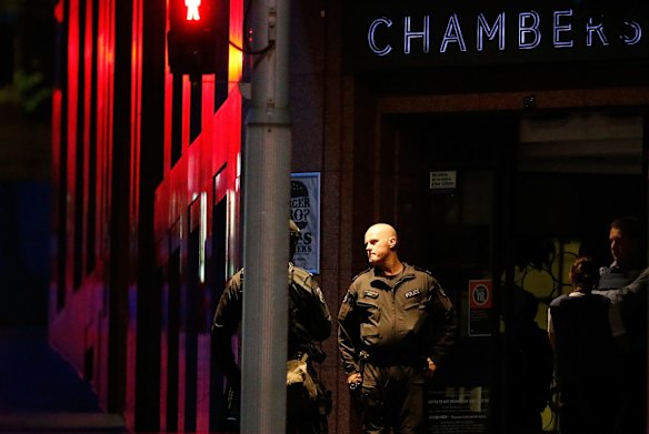 Police officers talk next to Lindt cafe, Martin Place.