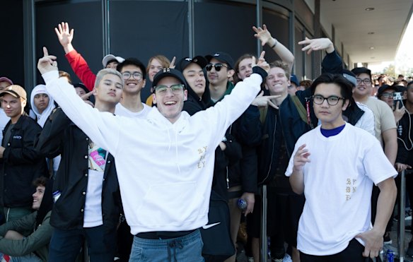 Michael Klein, centre, and Pablo Leopando, who were the first couple in the store model their purchases for all the other Kanye West fans lining up for the opening of his pop up clothing store in Bondi, Sydney. Michael Klein who was third in line started queuing at 6 pm the night before while Pablo Leopando paid someone to queue for him.