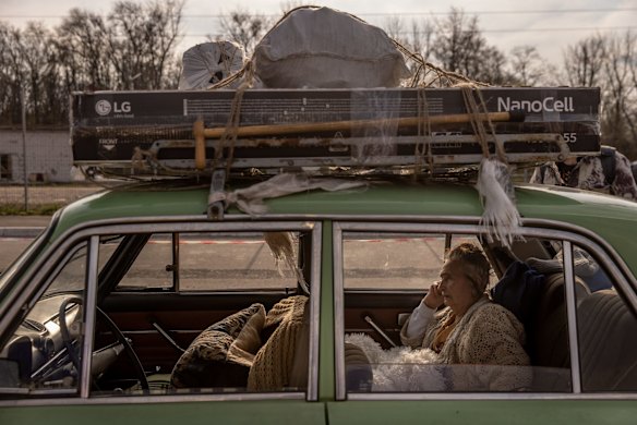 Varta, 81 of Mariupol, rests in the back of her family's car after a four-day journey to an evacuation point for people fleeing from Mariupol, in Zaporizhzhia, Ukraine.