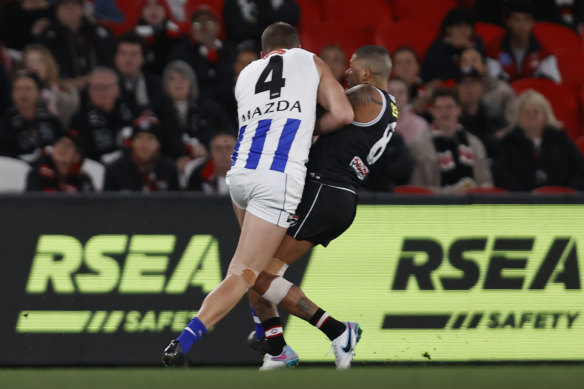 Heavy crunch: Bradley Hill is collected by Aidan Corr in Sunday’s match at Marvel Stadium.