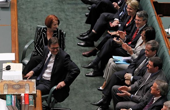 Prime Minister Julia Gillard and Climate Change Minister Greg Combet receive applause from ALP colleagues during the passing of the carbon tax bills.