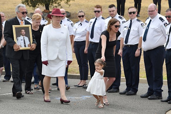 Errol O'Dwyer (left), Melissa O'Dwyer and young daughter Charlotte the family of NSW RFS volunteer Andrew ODwyer during his funeral service.
