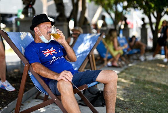 Geoffrey Jeffries relaxes with a beer at the Australian Open on Australia Day.