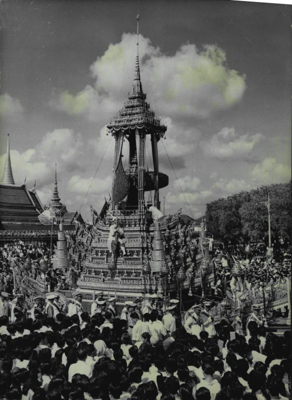 The funeral procession behind the carriage taking the remains of King Ananda Mahidol moves through the streets of Bangkok.