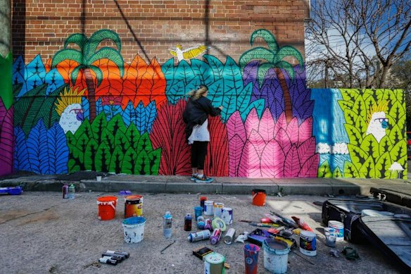 Mulga's assistant touching up his artwork at 10 Pearl Street, Newtown, as part of Marrickville council's Perfect Match pro-public art program.