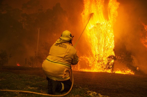 Wreck Bay fire crew protect a property on Jindelara Creek Rd from the Currowan fire. 
