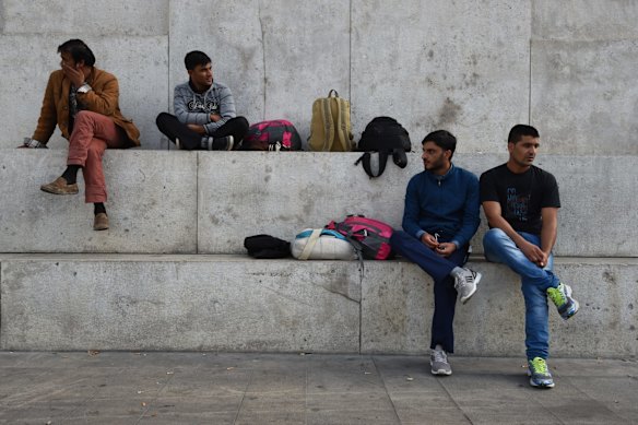 Refugees from Pakistan sit on the steps of the Milan Central Station passing the time. The men have been living in refugee centres since last October and are waiting for their papers allowing them to work in Italy. They rely on charities and the Italian government for food and shelter. 