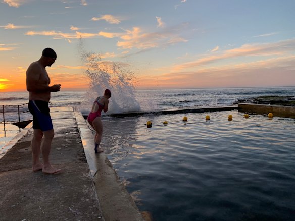 Early morning swimmers at Austinmer beach in Wollongong. Photo taken at sunrise.