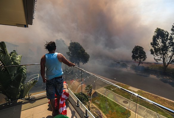 Ange Vlahopoulos watches as the fire approaches his home.