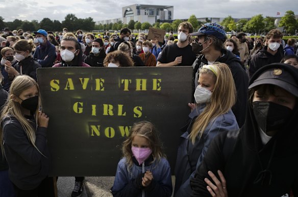 People hold a poster demanding the security of girls and other people in Afghanistan during a demonstration in Berlin, Germany. Several hundred people attended a demonstration to support an air bridge to bring people out of the Taliban-controlled country. 