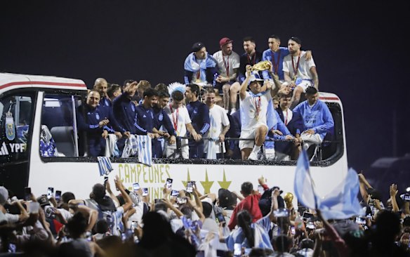 Argentina men's national football team player Lisandro Martinez holds up the FIFA World Cup as they arrive to the teams headquarters after winning the FIFA World Cup Qatar 2022 in Buenos Aires, Argentina.