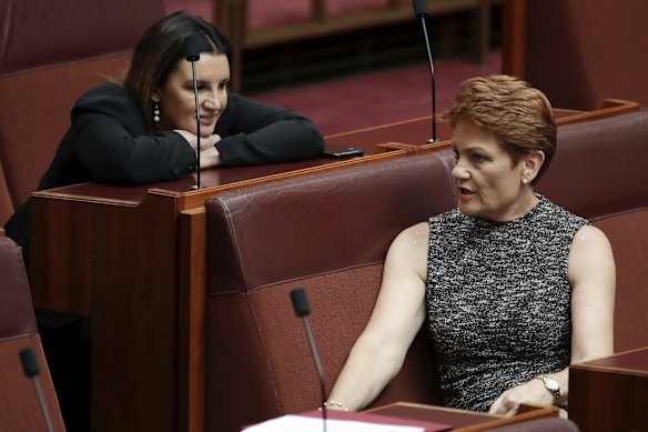 Senators Jacqui Lambie and Pauline Hanson during a division in the Senate at Parliament House in Canberra.
