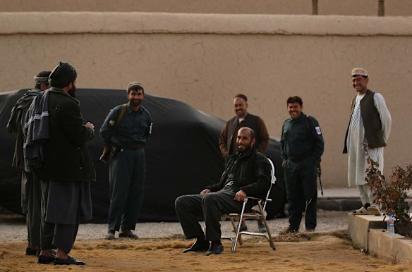 Uruzgan Police Chief, Matiullah Khan, seated, talks with his policemen and local men at his compound in Tarin Kowt, Uruzgan, Afghanistan.