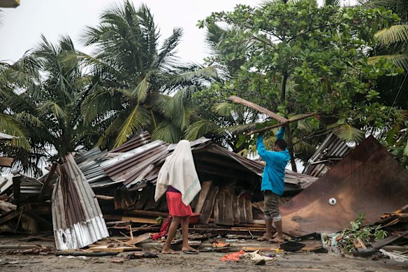 A man begins the task of rebuilding his home after it was damaged by Hurricane Irma in Nagua, Dominican Republic.