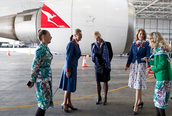 Qantas staff model cabin crew uniforms from over the 49 years of the 747 jumbo jet's service with the airline. 
