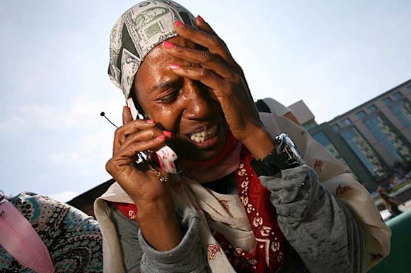 A woman cries on the phone as she tells a friend that Michael Jackson has passed away at UCLA Medical Plaza in Los Angeles, California.