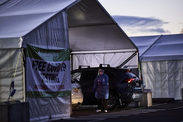 A medical worker is seen at the new 24-hour drive-through COVID-19 testing clinic at the Mounties Club car park in Mount Pritchard. New rules dictating that essential workers from the Fairfield LGA must be tested every three days if they are leaving the area come into force today. 17 July, 2021.

