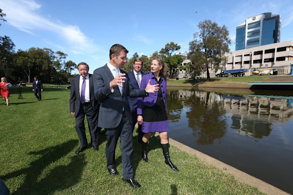 Paul Garrard, Mike Baird, Troy Grant and Dolla Merrillees walking along Parramatta river accross from the proposed new location for Parramatta for the new Powerhouse Museum.