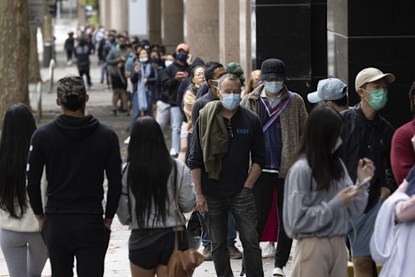 A man in line to get a COVID-19 test looks into the camera in Sydney's CBD on Tuesday, December 28, 2021.