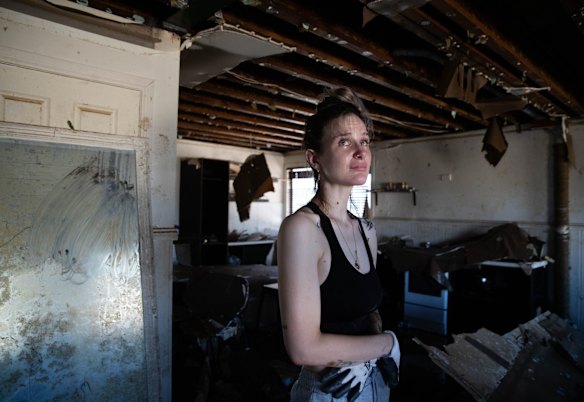 Emily Chave is overwhelmed by the destruction of her home in Woodburn as she enters it for the first time after flood waters receded in the Northern Rivers region of NSW.