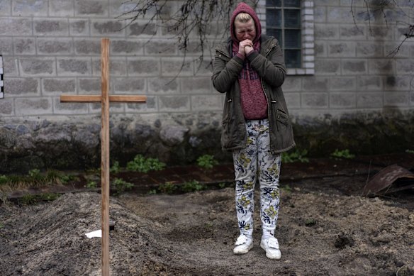 Mariya Ol'hovs'ka mourns the death of her 72-year-old father, Valerii Ol'hovs'kyi, killed by a Russian missile days earlier near his home on the outskirts of Kyiv.