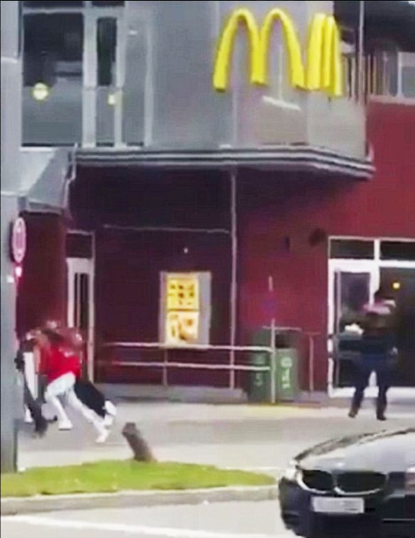 A screenshot from a video purporting to show the shooter, dressed in black, firing 20 shots.